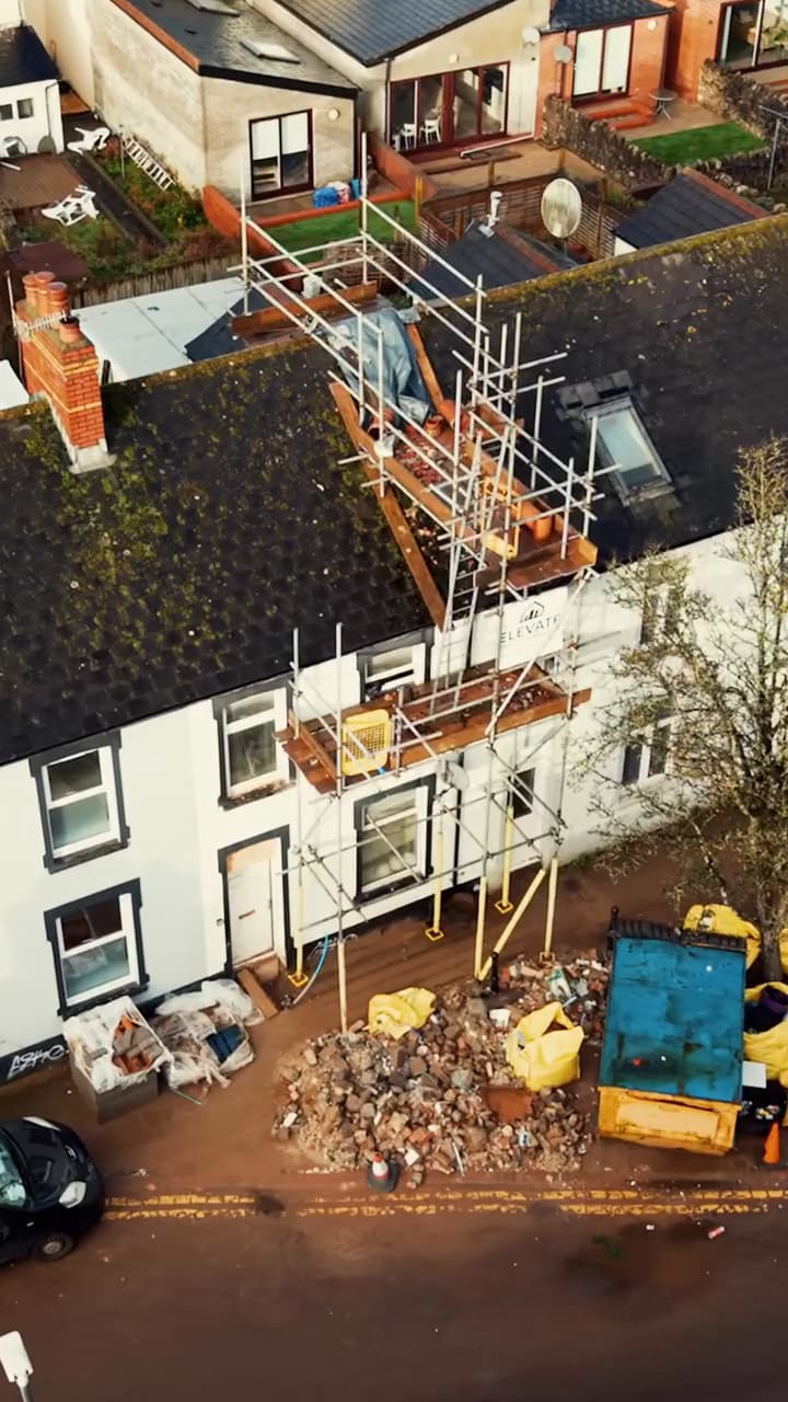 Drone view of a Cardiff terrace with scaffolding and a skip during development