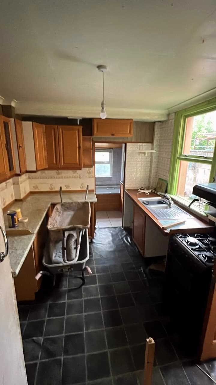 Dated original kitchen in the three-bed house before conversion